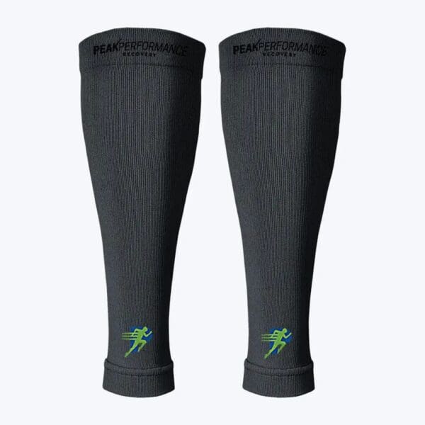 A pair of black leg warmers with green lightning bolts on them.