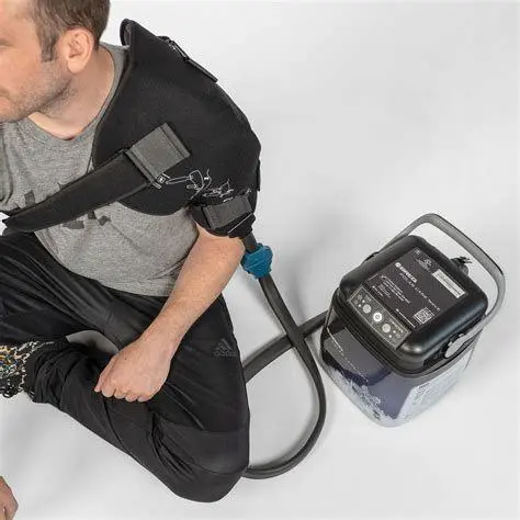 A man sitting on the ground with an electric device.