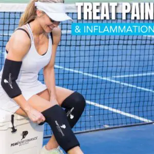 A woman sitting on the tennis court with her knee pads.