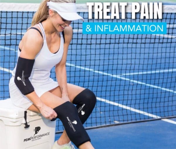 A woman sitting on the tennis court with her knee pads.