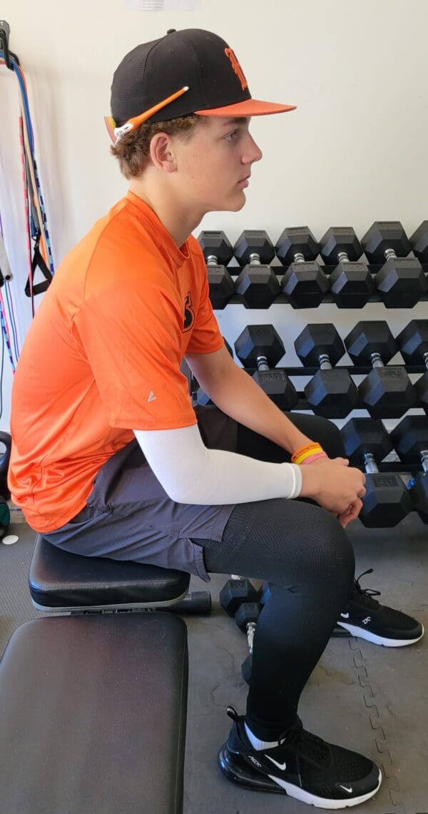 A man sitting on a bench in the gym